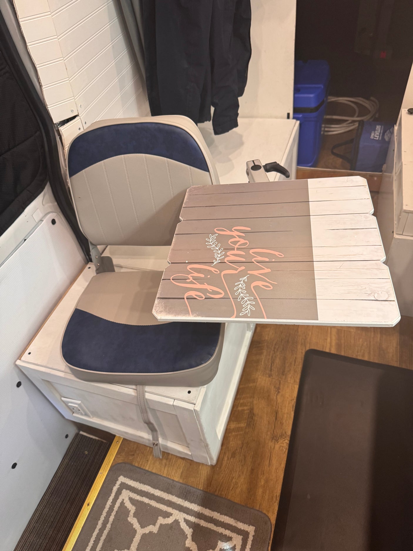 Explore this rv rental's interior: comfy bench seat, attachable table, and smart storage solutions.