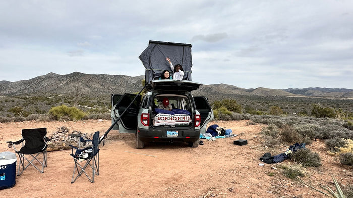 waters. Great comfort for road trips or any rv rental alternative.|Inside an RV rental car setup: rear seat holds a blue sleeping bag and pillow