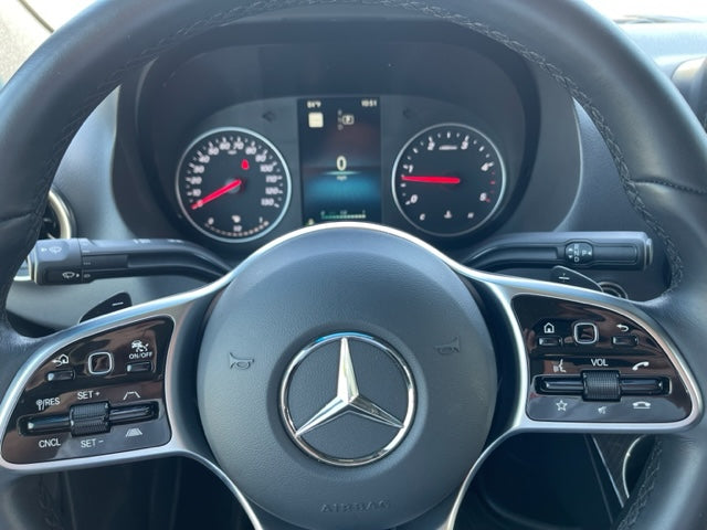 Modern Mercedes-Benz RV rental interior: dashboard, steering wheel, and digital instrument cluster with controls.