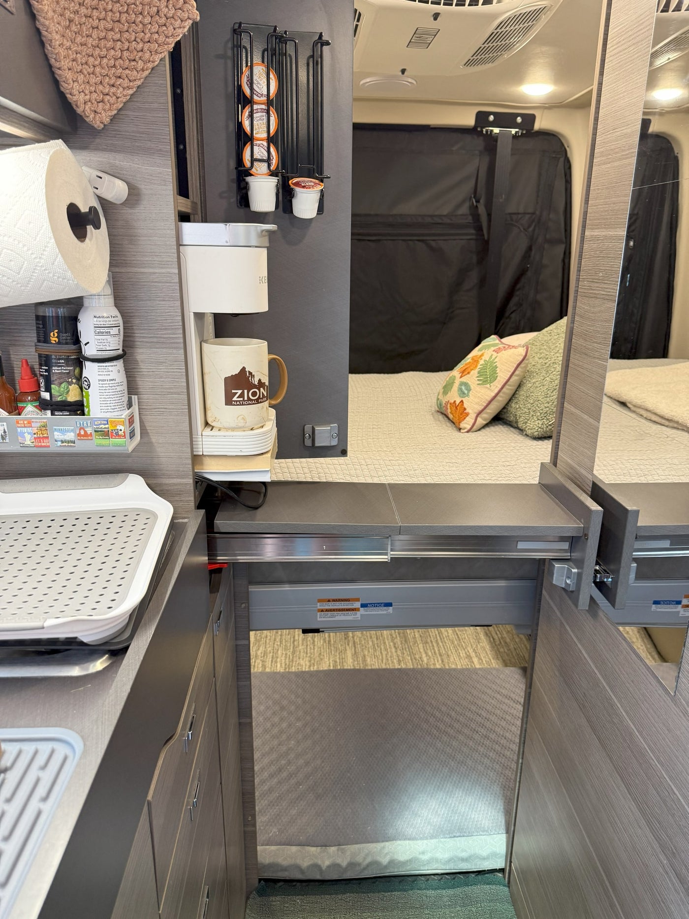 offering scenic mountain views under cloudy skies.|RV rental front cabin interior with black leather seats — photo 14