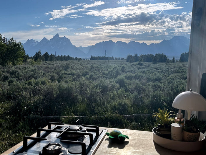 plus a comfy bed. Ideal for van life.|Steaming kettle on an RV rental stove