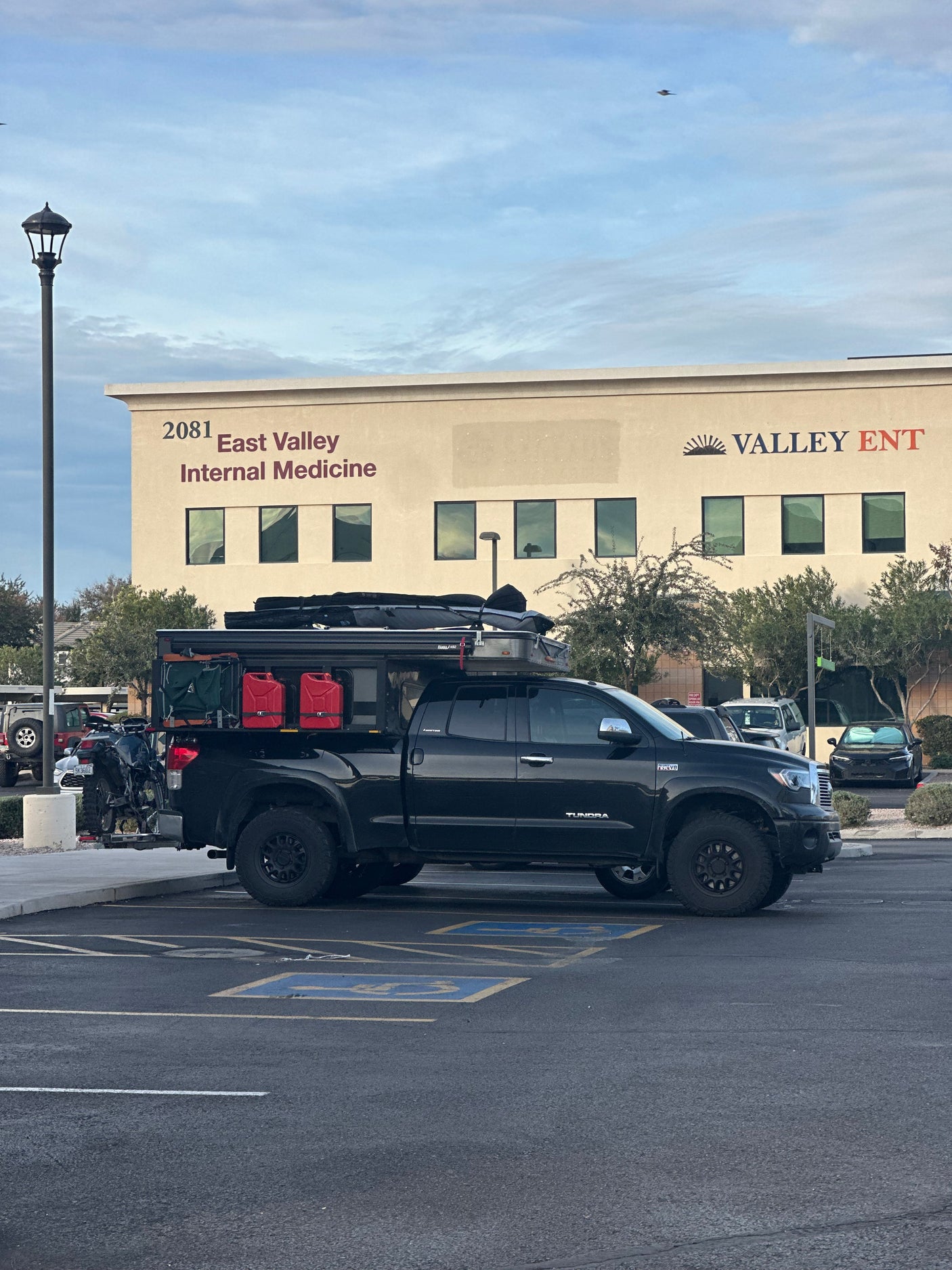 Black overlanding pickup with rooftop tent