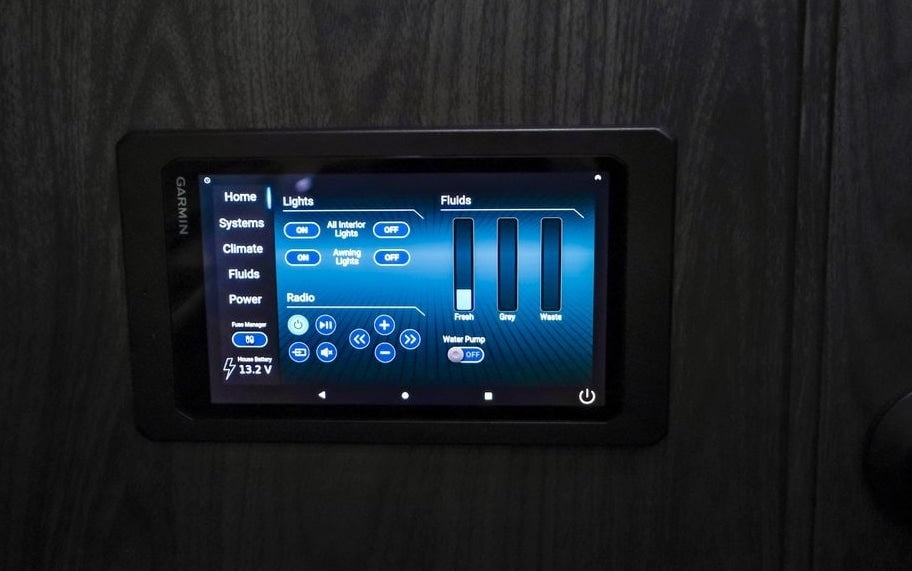 Garmin smart control panel in an RV rental. Monitor lights, water levels (fresh, grey, waste), radio, and power systems.