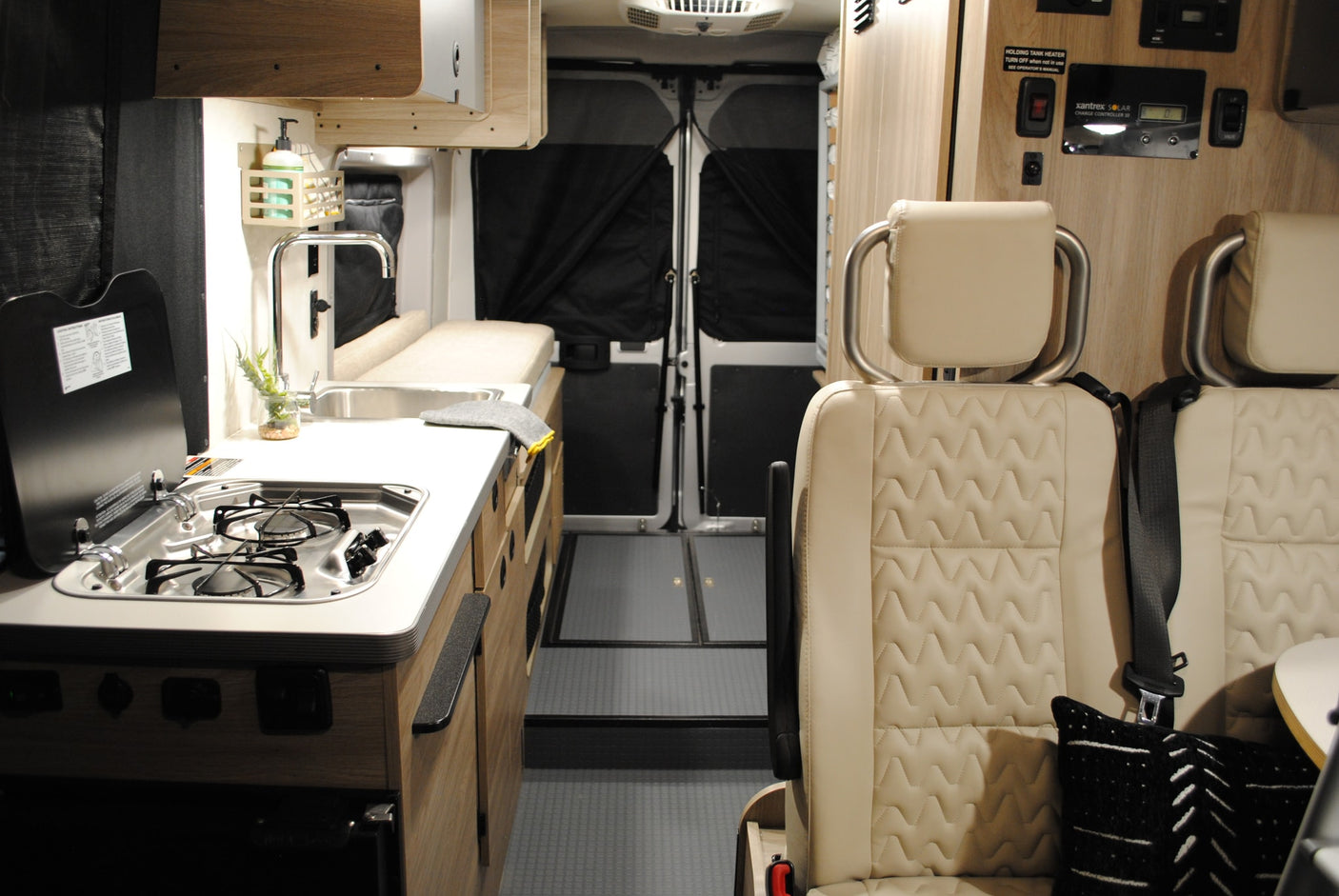 is parked by a golden lake. Perfect for your rv rental adventure.|This inviting RV rental interior features a cozy bed with stylish bedding