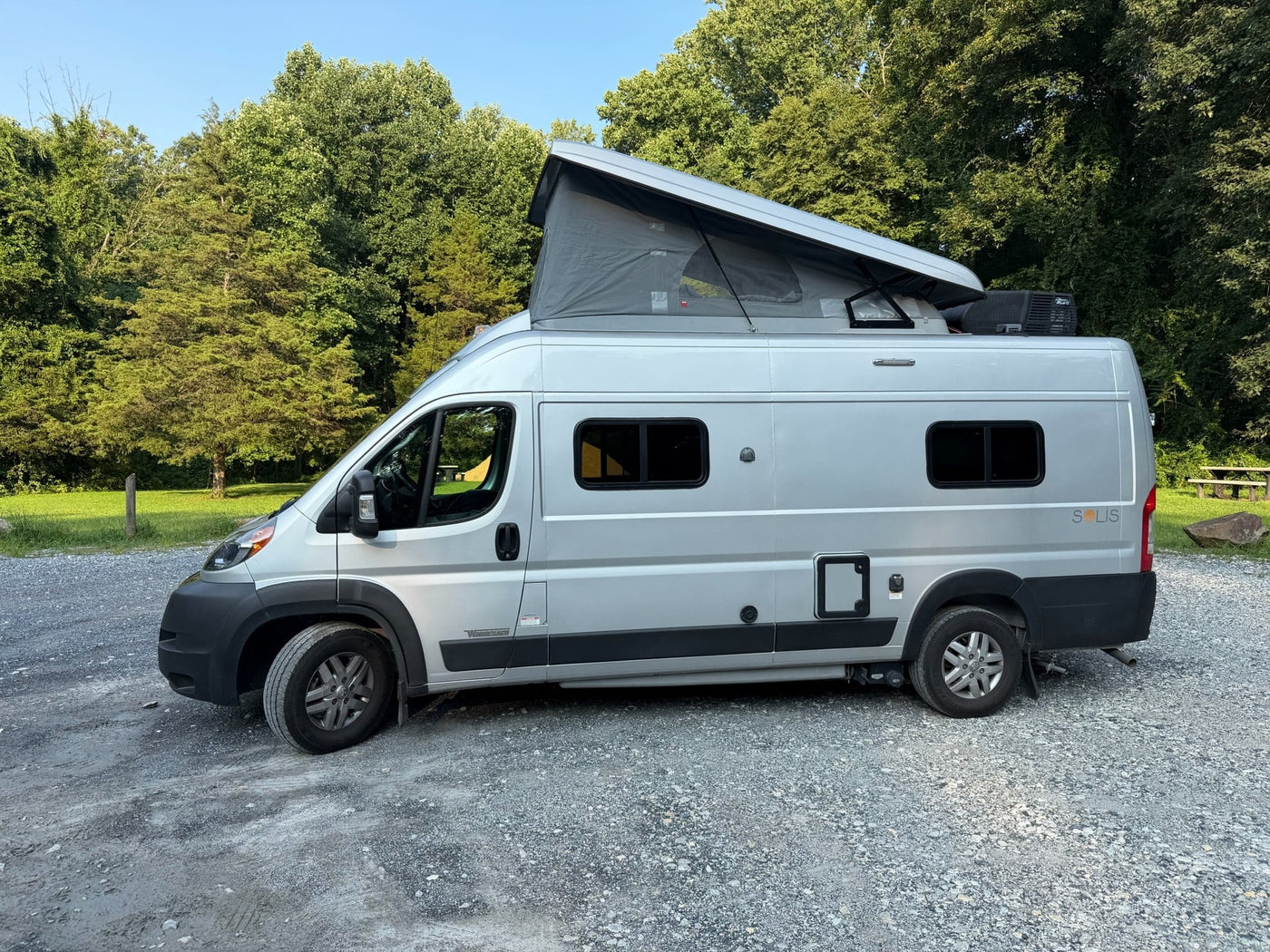 and open back doors to nature.|Inside an **rv rental**: front swivel seats — photo 12