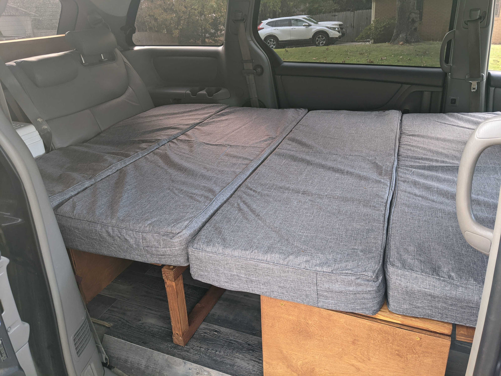 ideal for van life camping. Features a built-in mobile cooking station.|Enjoying a roadside stop from our RV rental! Friends grab drinks from the Yeti cooler
