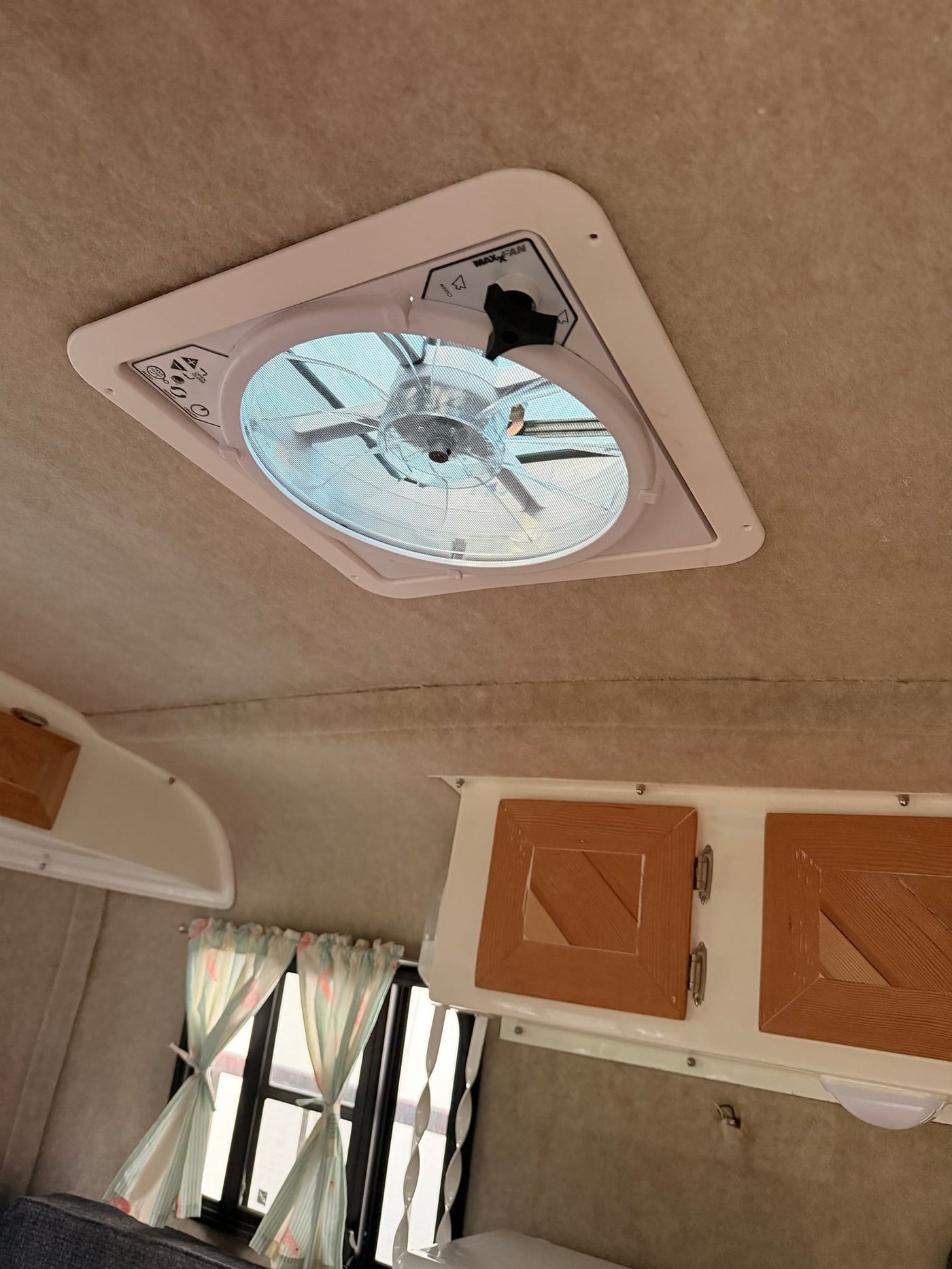 and a side seating area.|RV rental interior features a cozy dinette with a wood table — photo 13