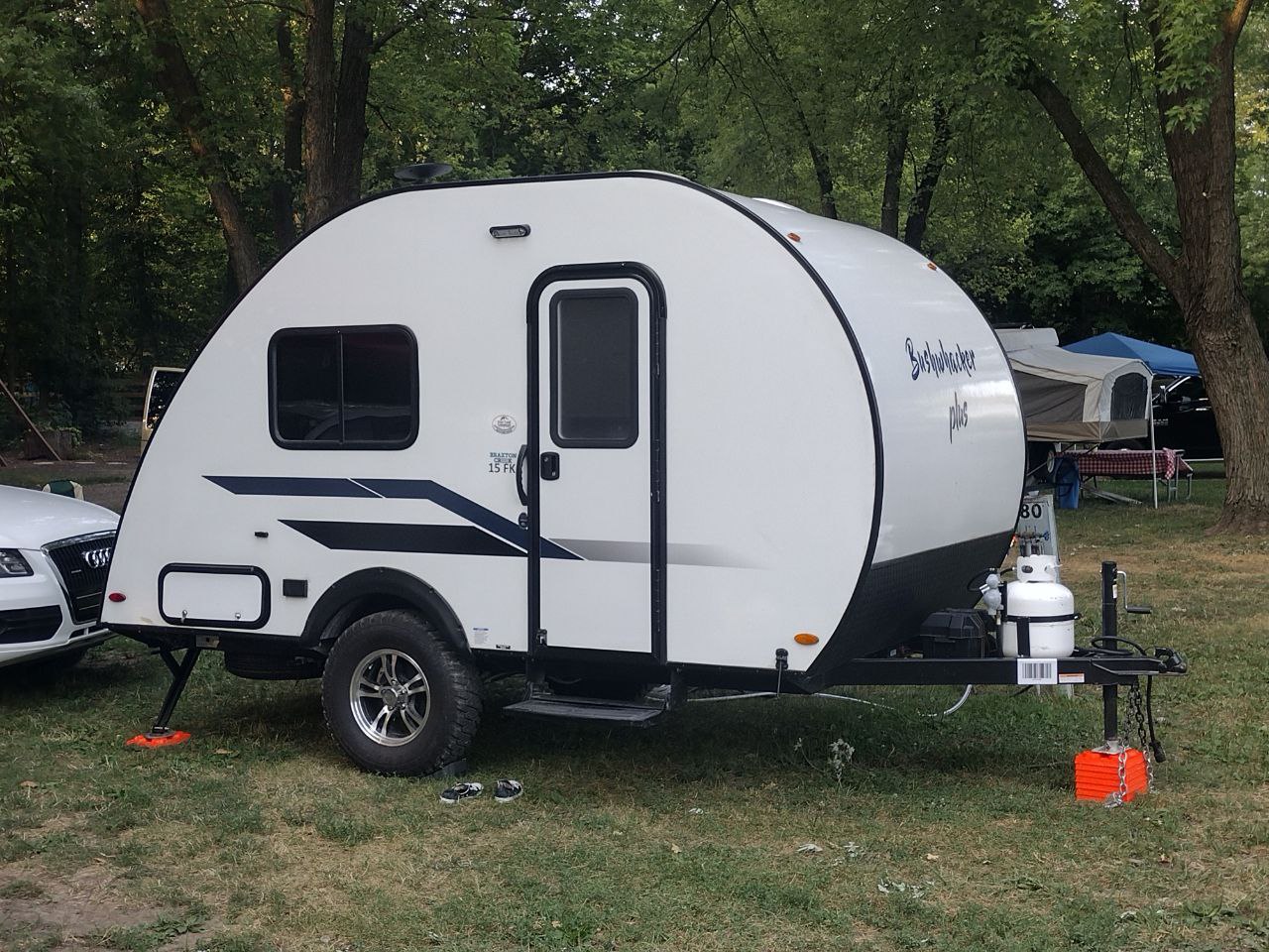Small white Bushwhacker Plus travel trailer RV rental