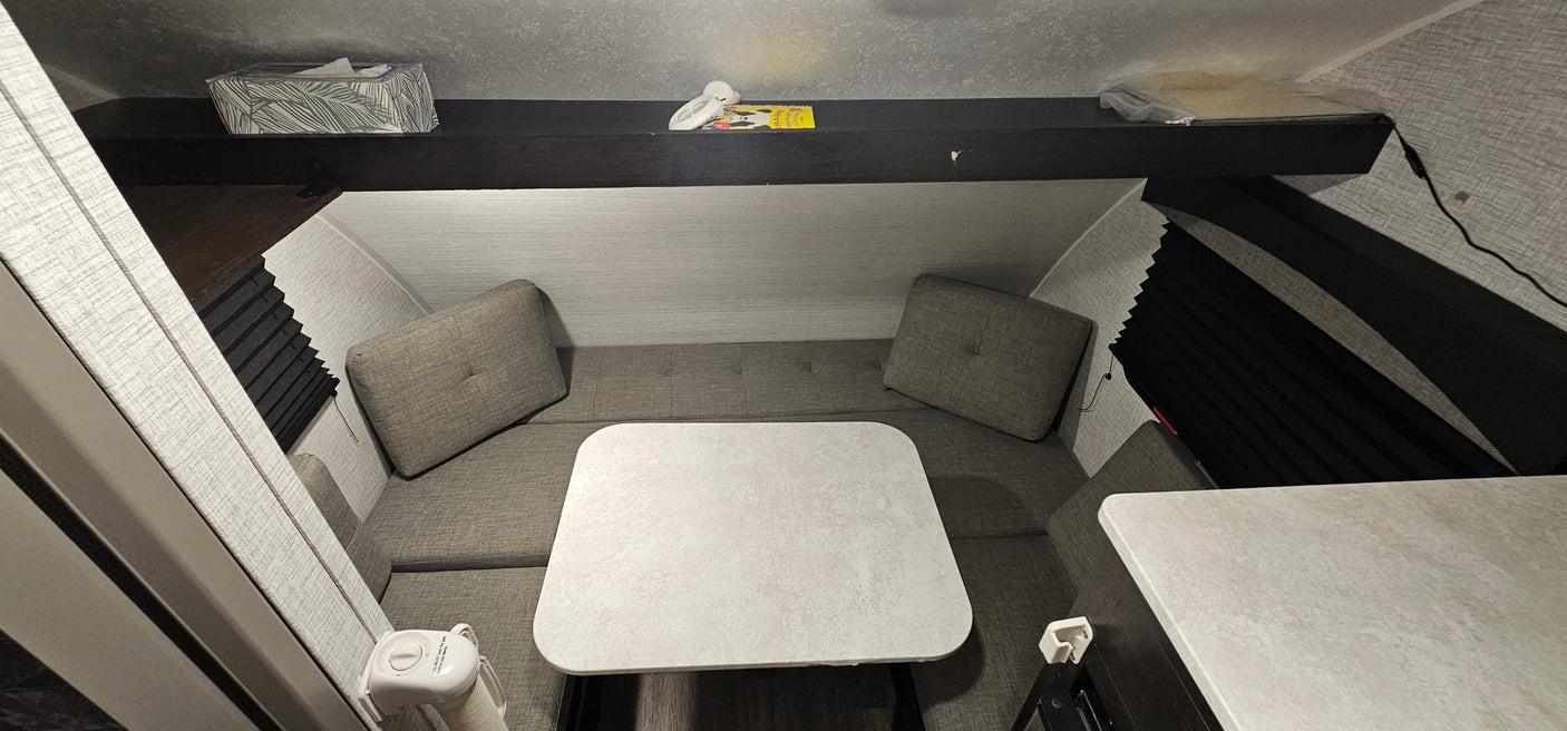 and wall AC unit.|RV rental interior: View of convertible gray seating/bed