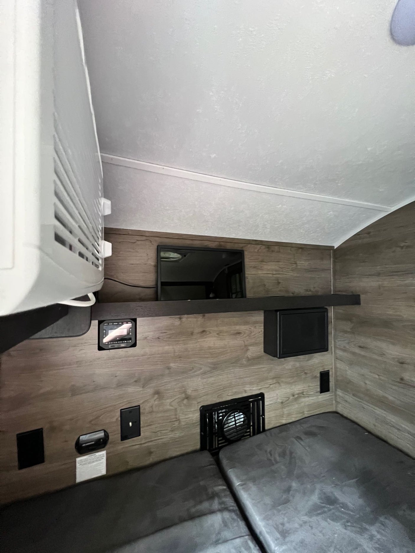 featuring robust tires & roof racks.|Cozy RV rental interior featuring a versatile grey sofa/bed