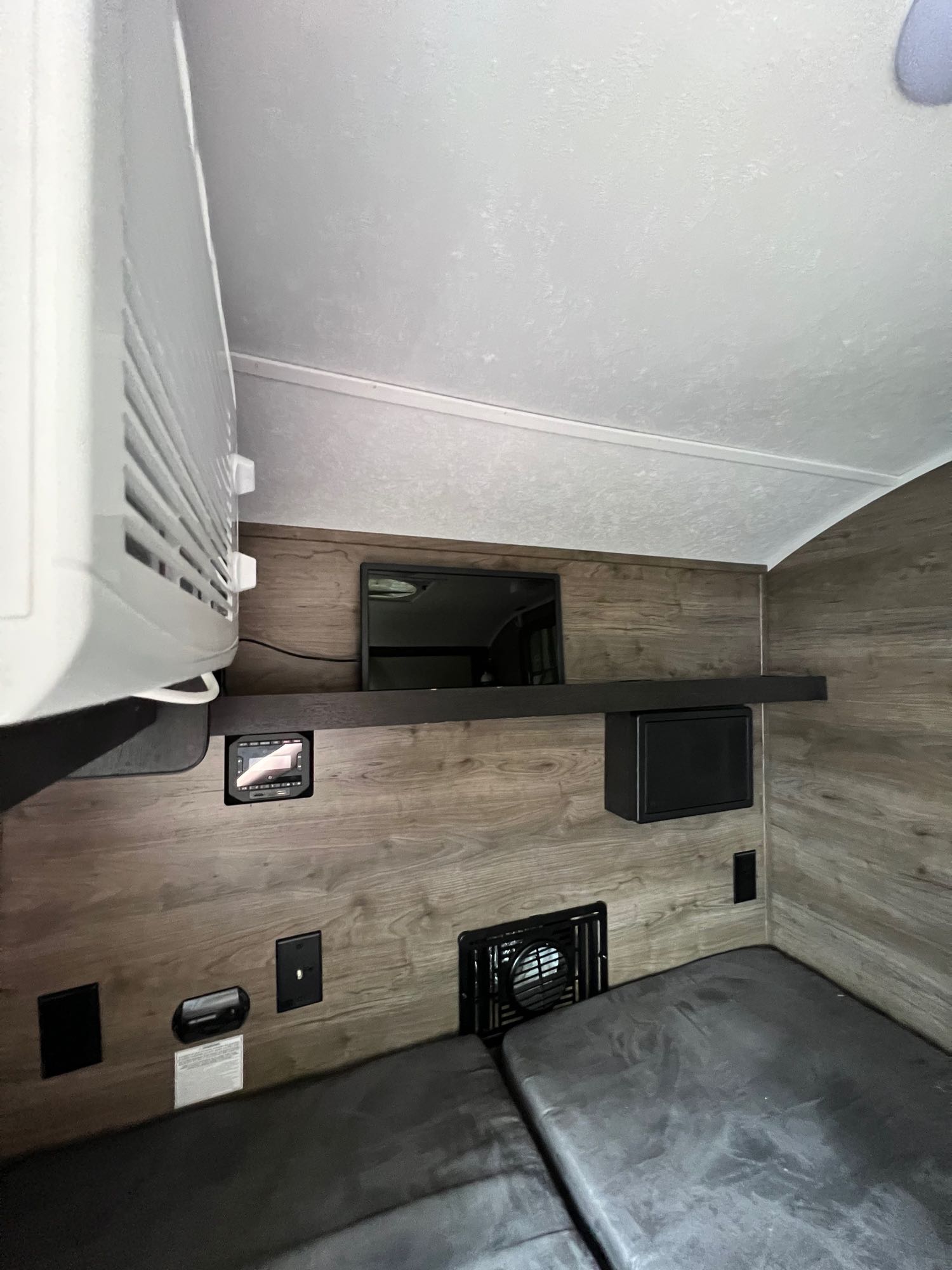 featuring robust tires & roof racks.|Cozy RV rental interior featuring a versatile grey sofa/bed