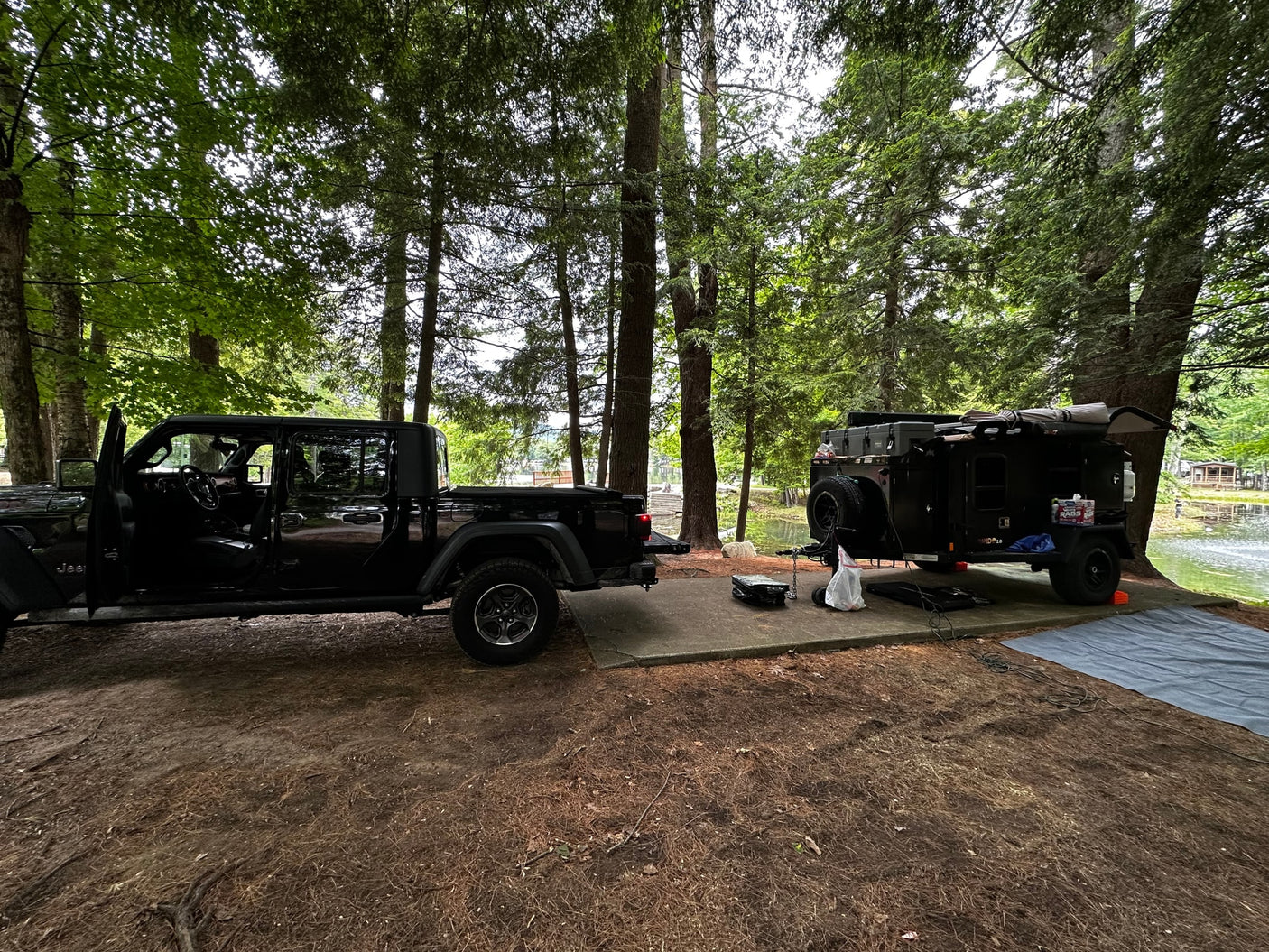 ready for adventure.|Black OFF GRID PANDO 2.0 trailer w/ rooftop tent & awning. Perfect RV rental for off-grid camping adventures.|A robust black Pando 2.0 off-grid trailer