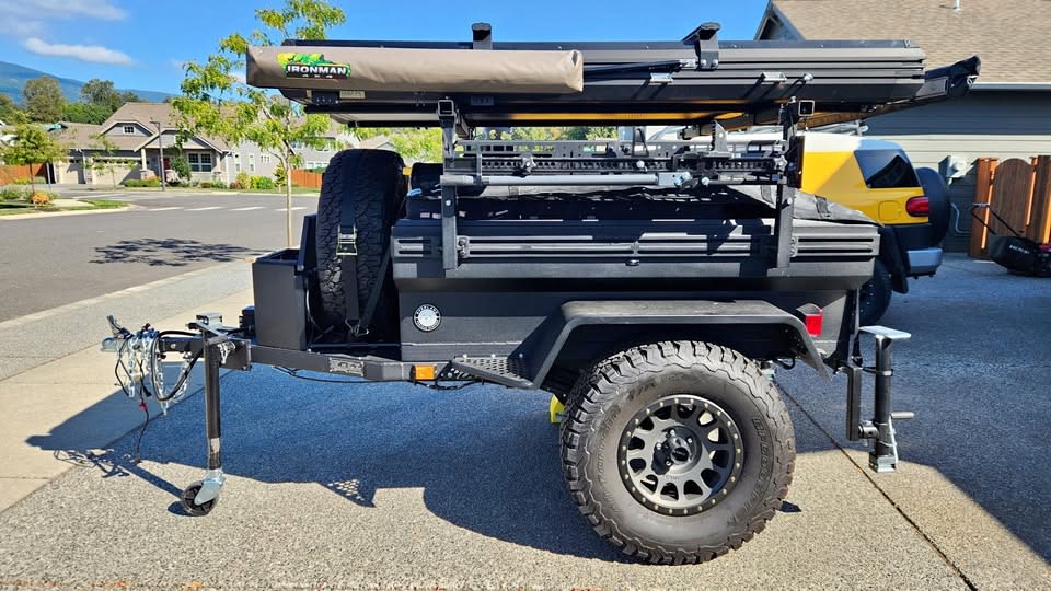 Rugged black overland trailer with rooftop tent & awning