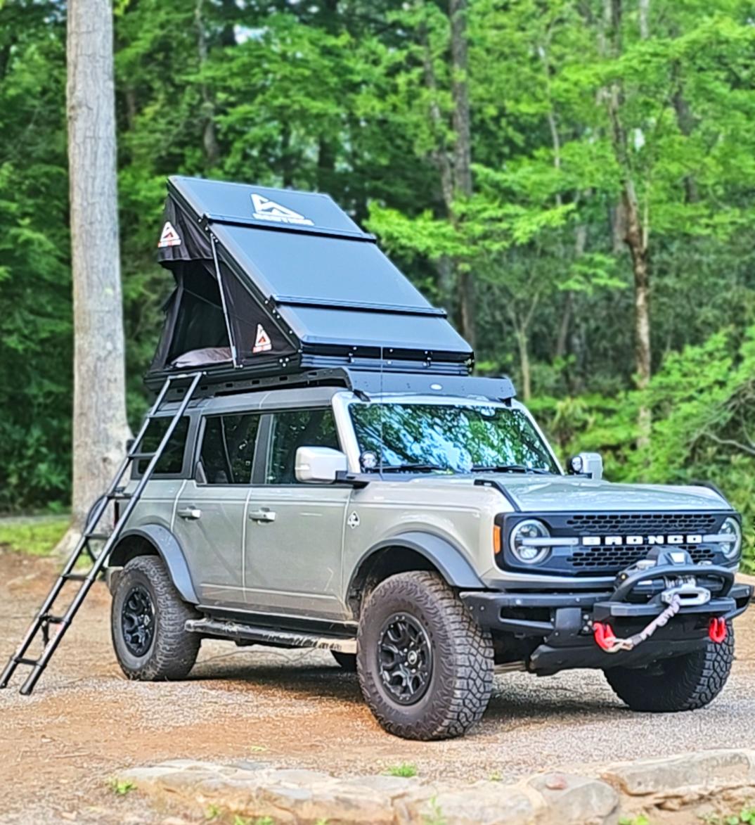 Adventure-ready Ford Bronco with a deployed rooftop tent & ladder
