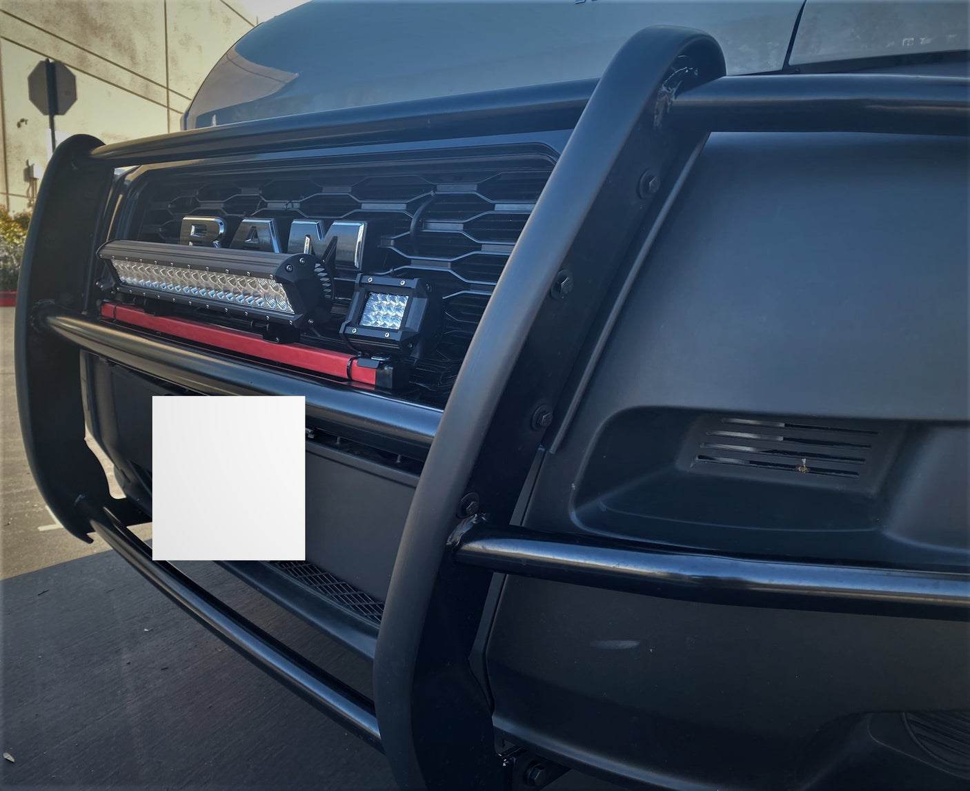 Close-up of a black RAM truck's grille, brush guard, and powerful LED lights. Perfect for heavy-duty RV rental towing.