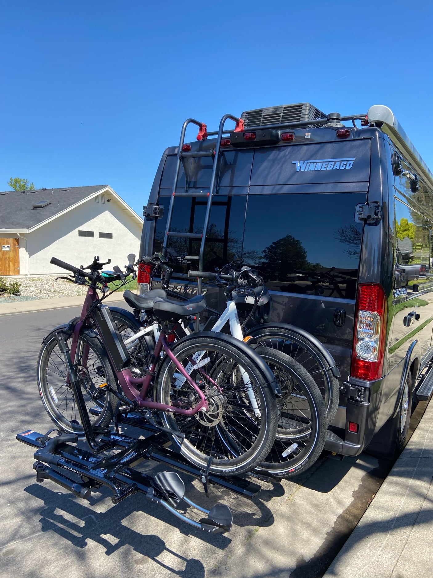Winnebago RV rental with two electric bikes on a bike rack. Ready for outdoor adventures & travel!