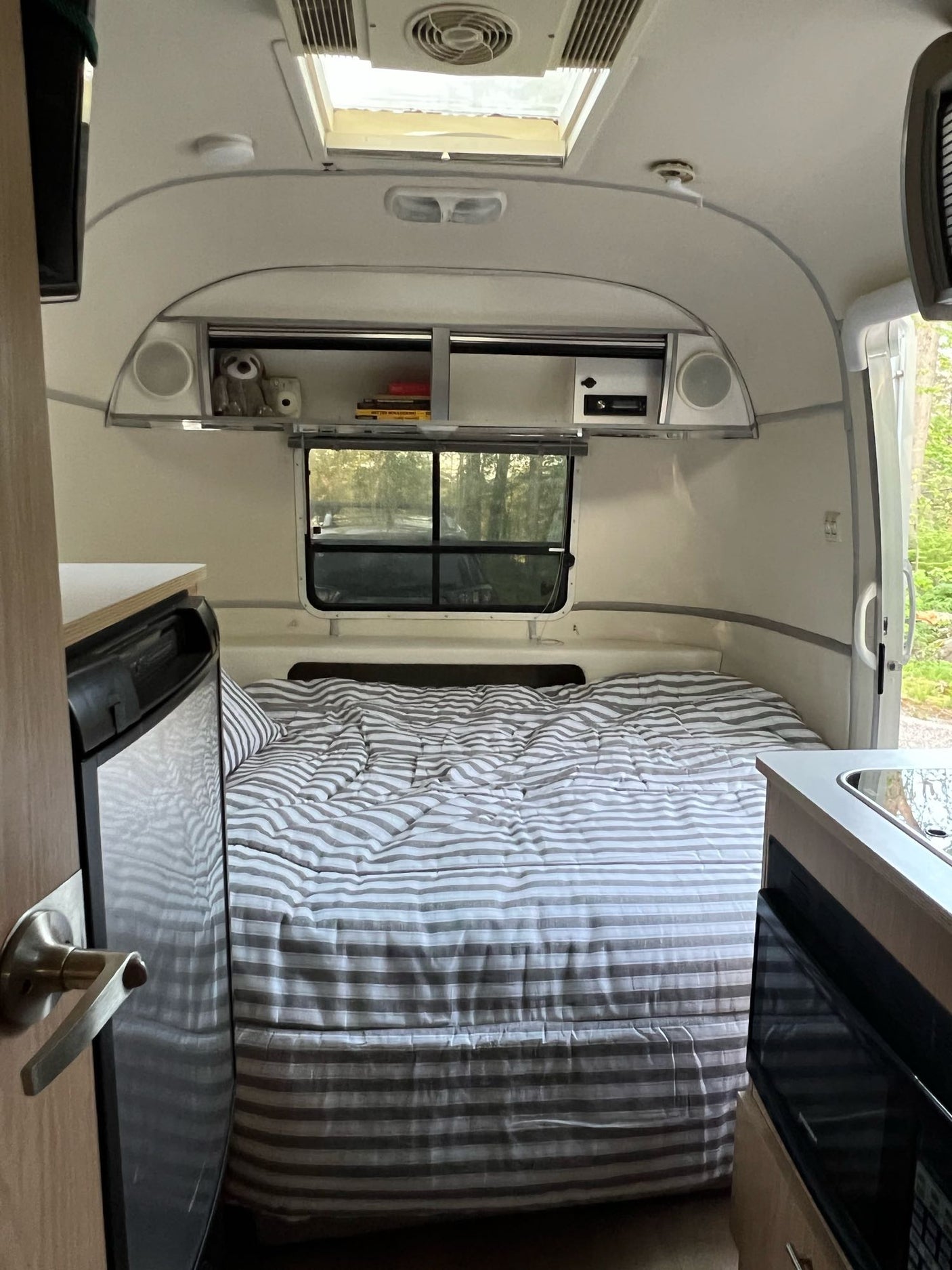 and wooden accents.|Inside a modern rv rental: bright wood kitchen with sleek appliances
