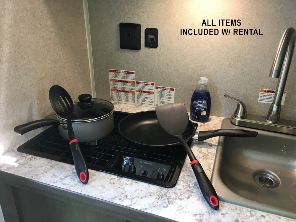 RV rental kitchen: stove, sink, pots, pans, utensils, and dish soap, all included for your convenience.