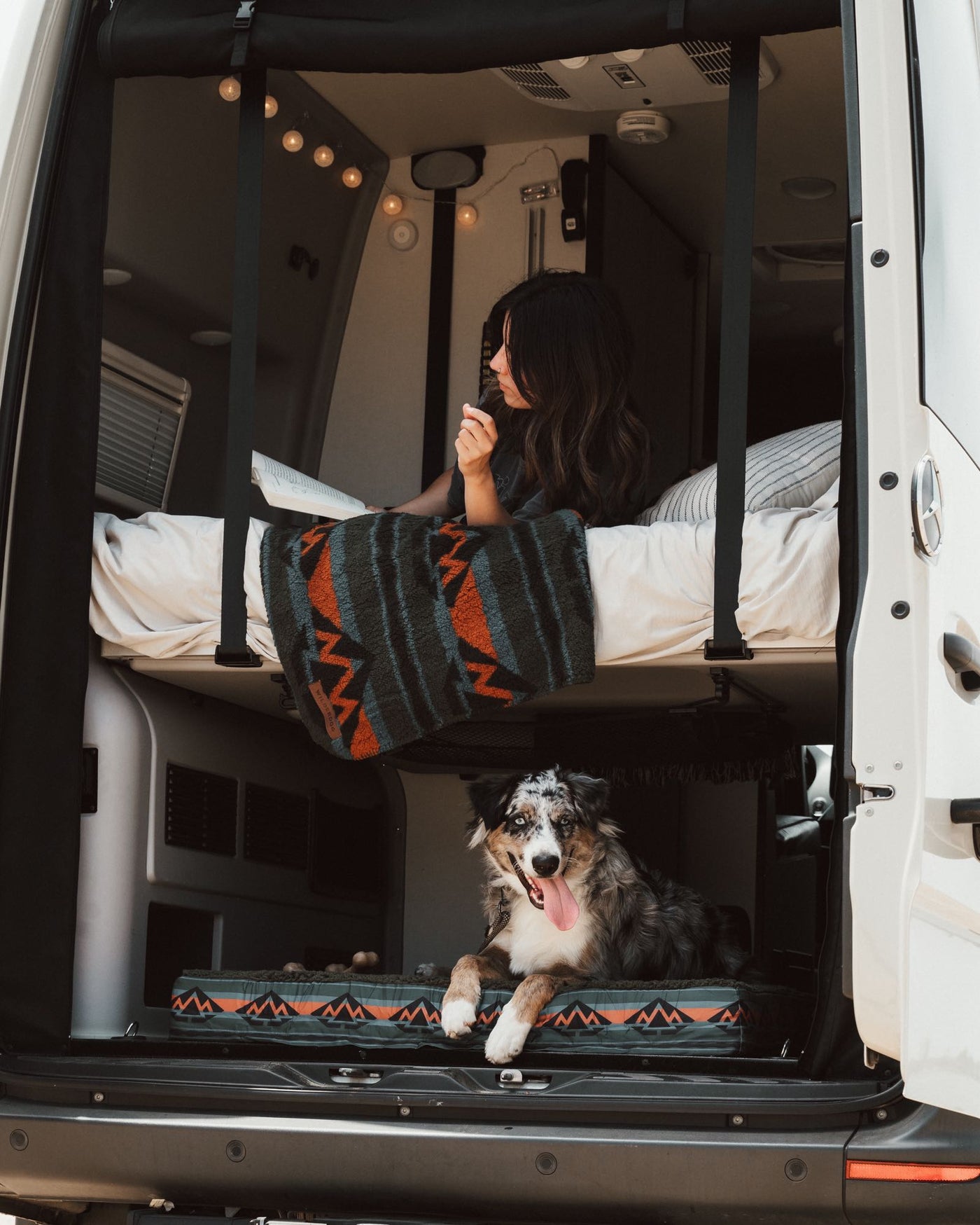 perfect for an off-grid nature adventure.|Cozy RV rental bedroom with an open book and stunning beach view — photo 2