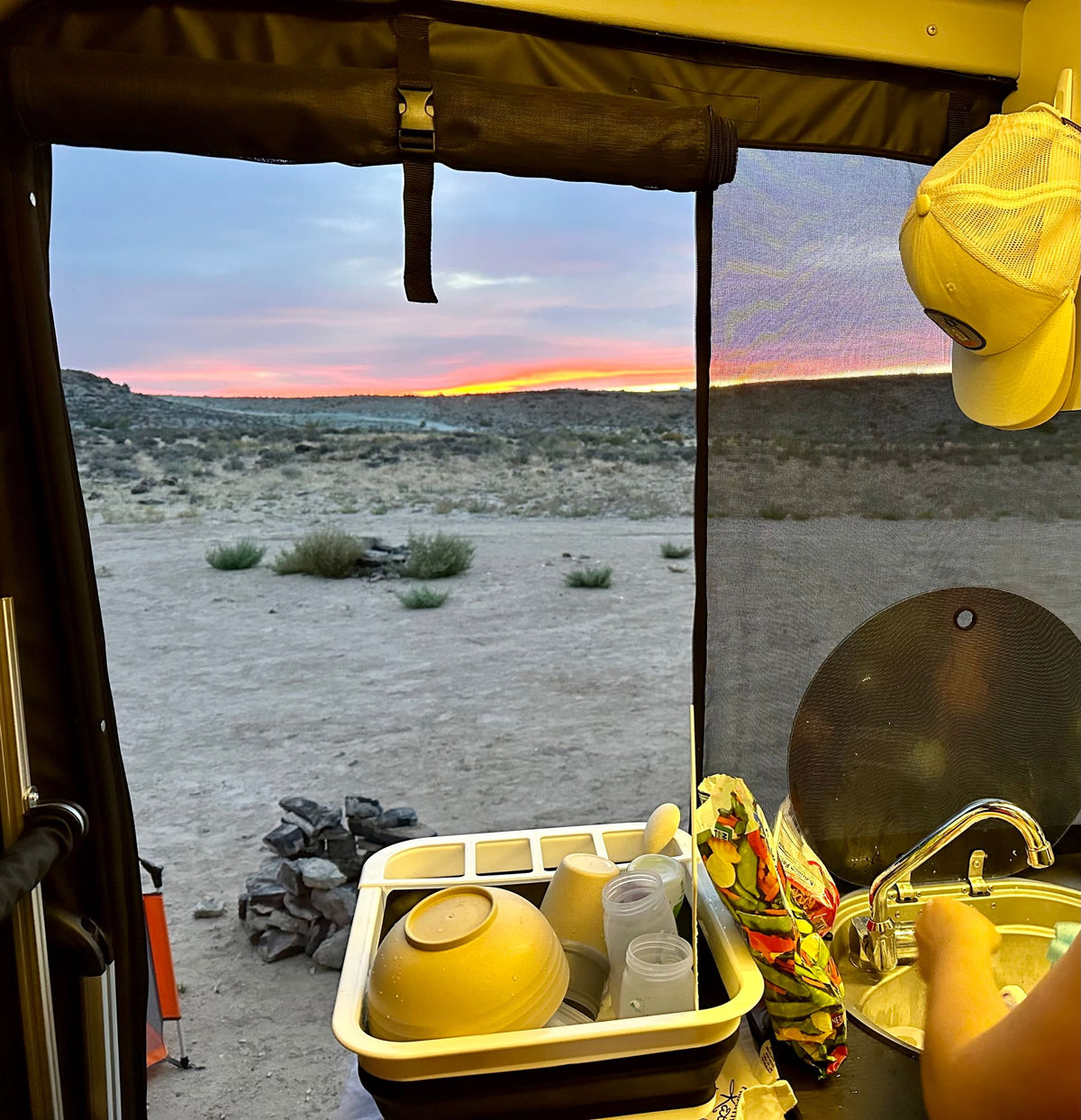 and bright lime green cabinets lead to the driver's area under warm lighting.|Stylish **rv rental** interior: kitchenette — photo 20