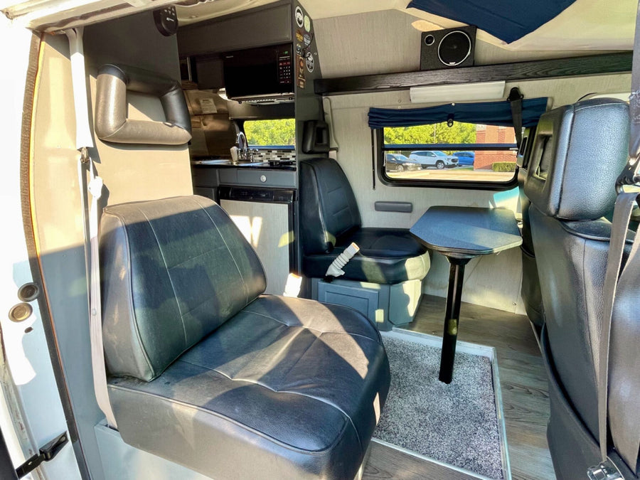ready for your next RV rental. Features a roof rack & side steps.|Step inside this **rv rental**! A comfortable camper interior featuring black seating