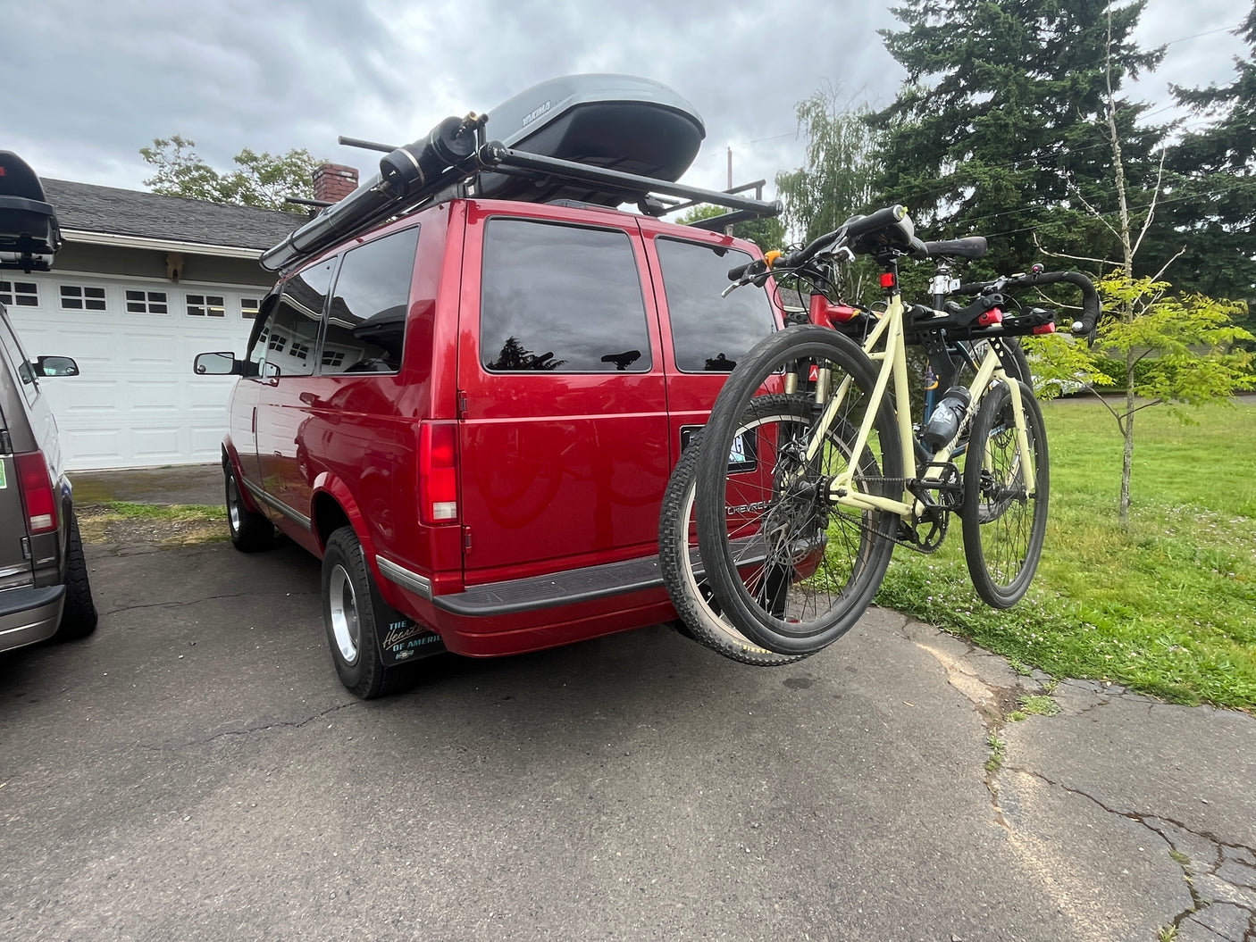 Adventure-ready red van with bike rack & roof box. Perfect rv rental for your outdoor road trip getaway.
