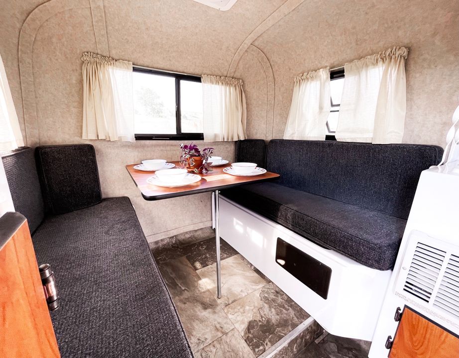 an ideal RV rental ready for adventure.|Compact RV rental interior: kitchen with stove & sink