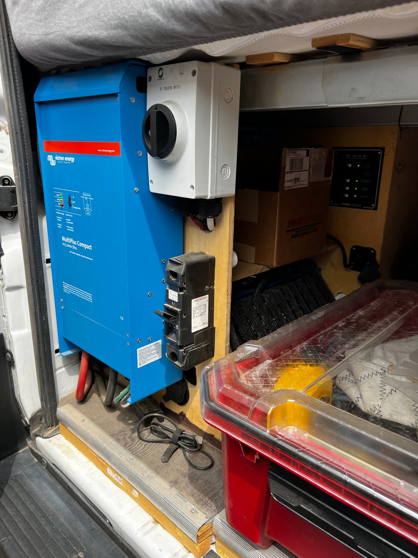RV rental power setup: A Victron MultiPlus Compact inverter/charger, DC isolator, and AC panel for off-grid power. — photo 14