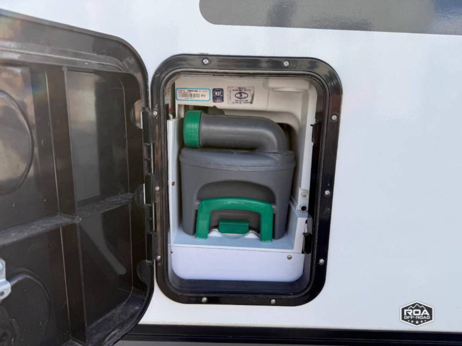 featuring a roof rack and ladder. This type of vehicle is popular for rv rental.|Sleek teardrop RV rental parked indoors. Notice the rear spare tire