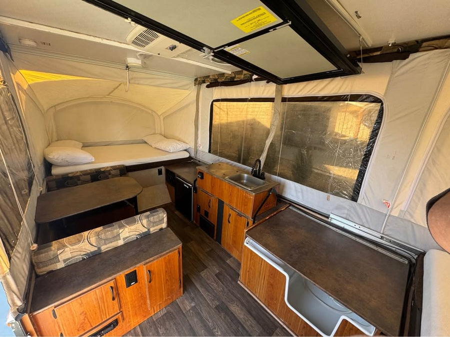 is extended and ready for your next camping adventure.|RV rental: Interior of a pop-up camper with two beds