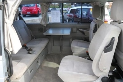 likely converts to a bed. Perfect for travel.|This RV rental’s outdoor kitchen pulls out from the back — photo 4