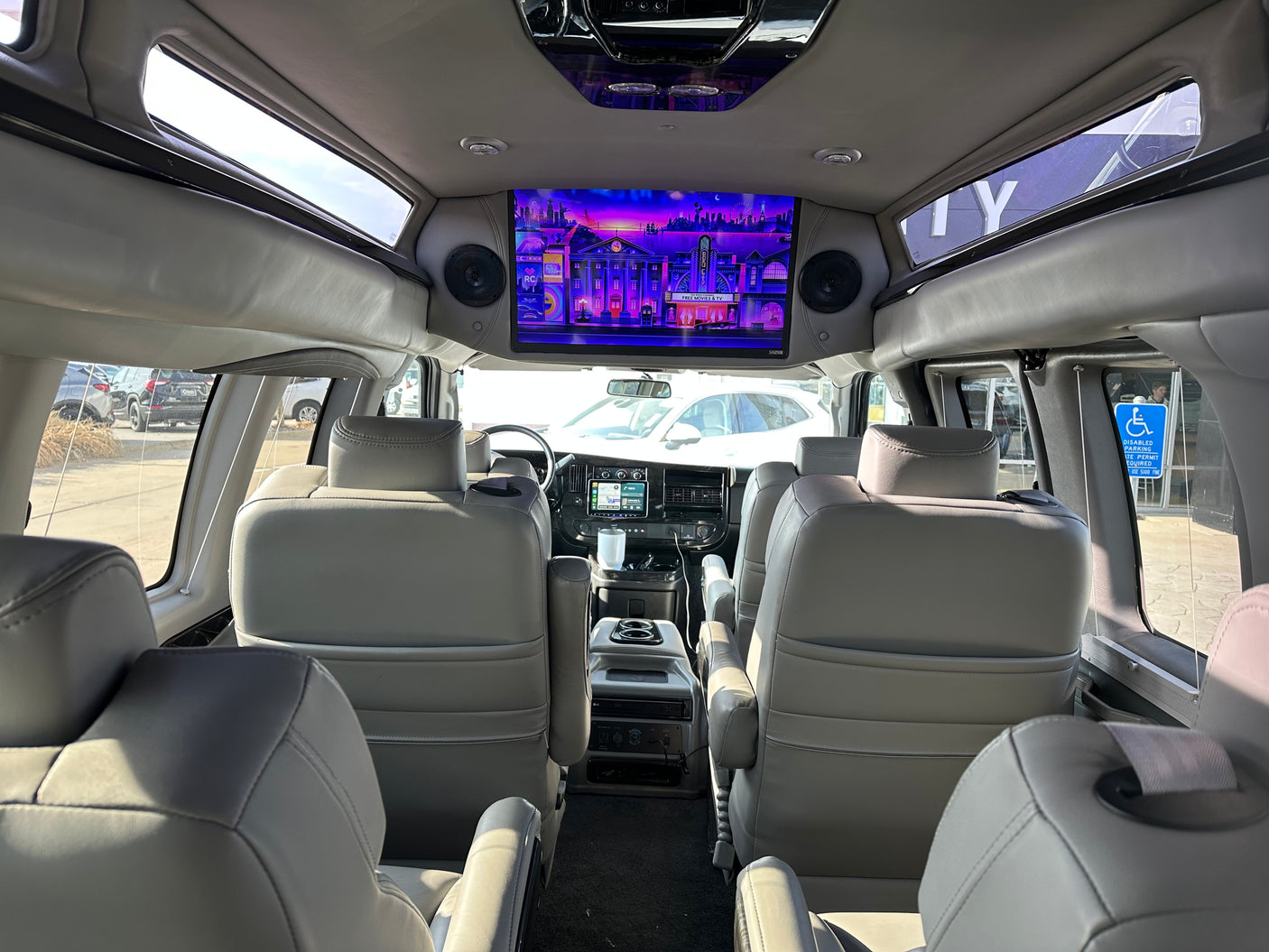 Experience an RV rental's luxury interior, featuring comfortable seating and a large TV screen for ultimate travel entertainment.
