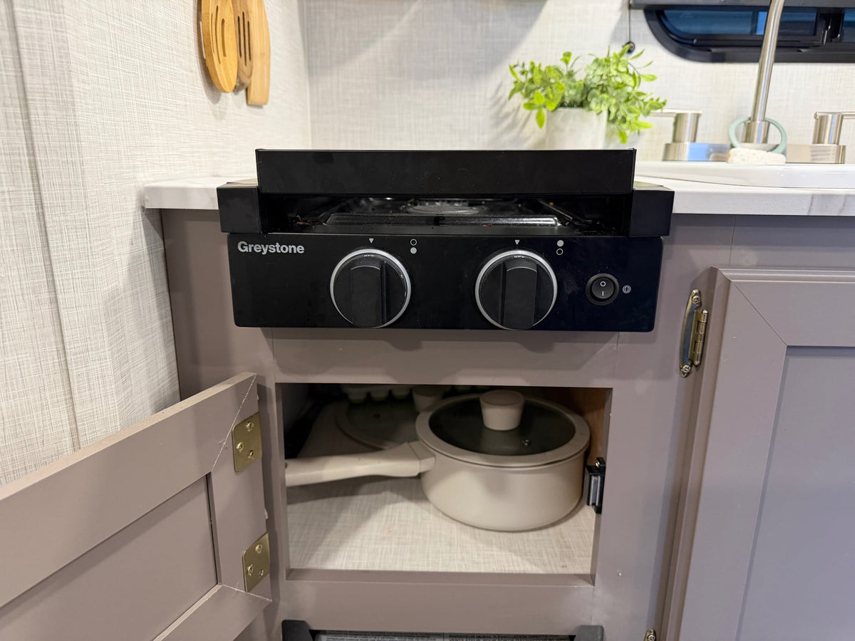 and a control panel.|This inviting RV rental dinette features a marble-look table — photo 14