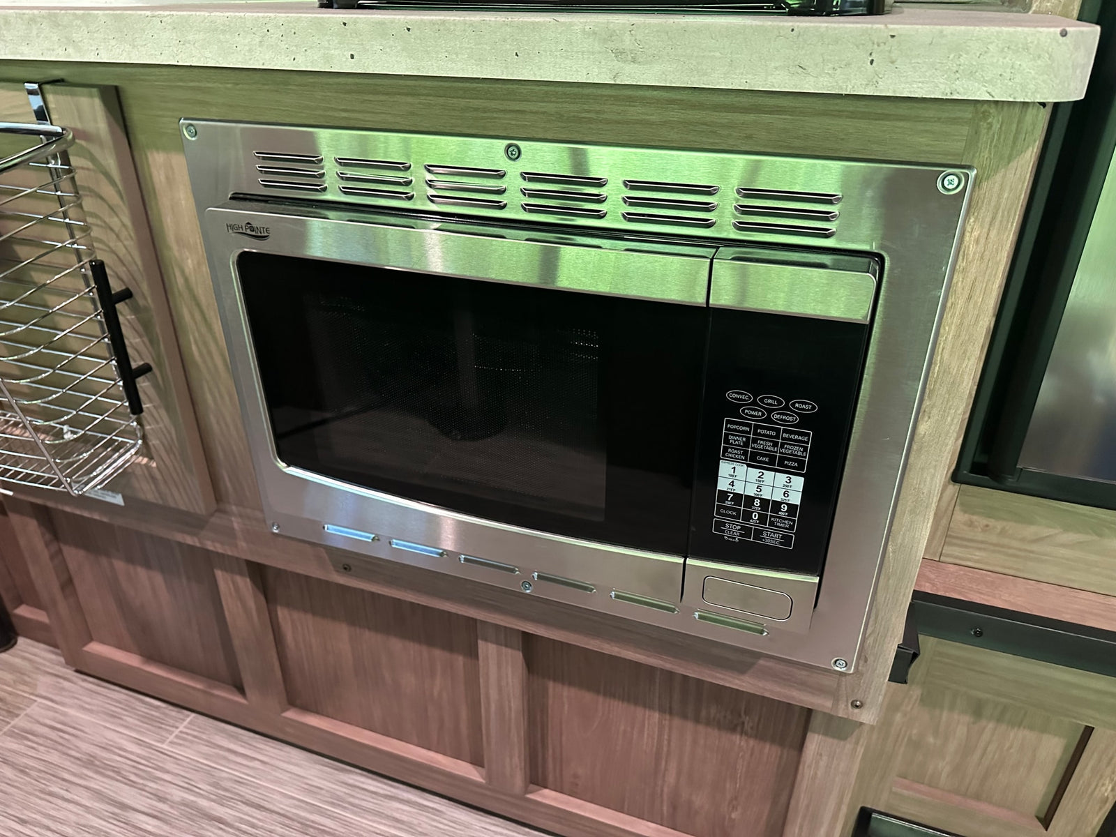 A built-in stainless steel High Pointe microwave oven in an RV rental's kitchen, perfect for convenient cooking.