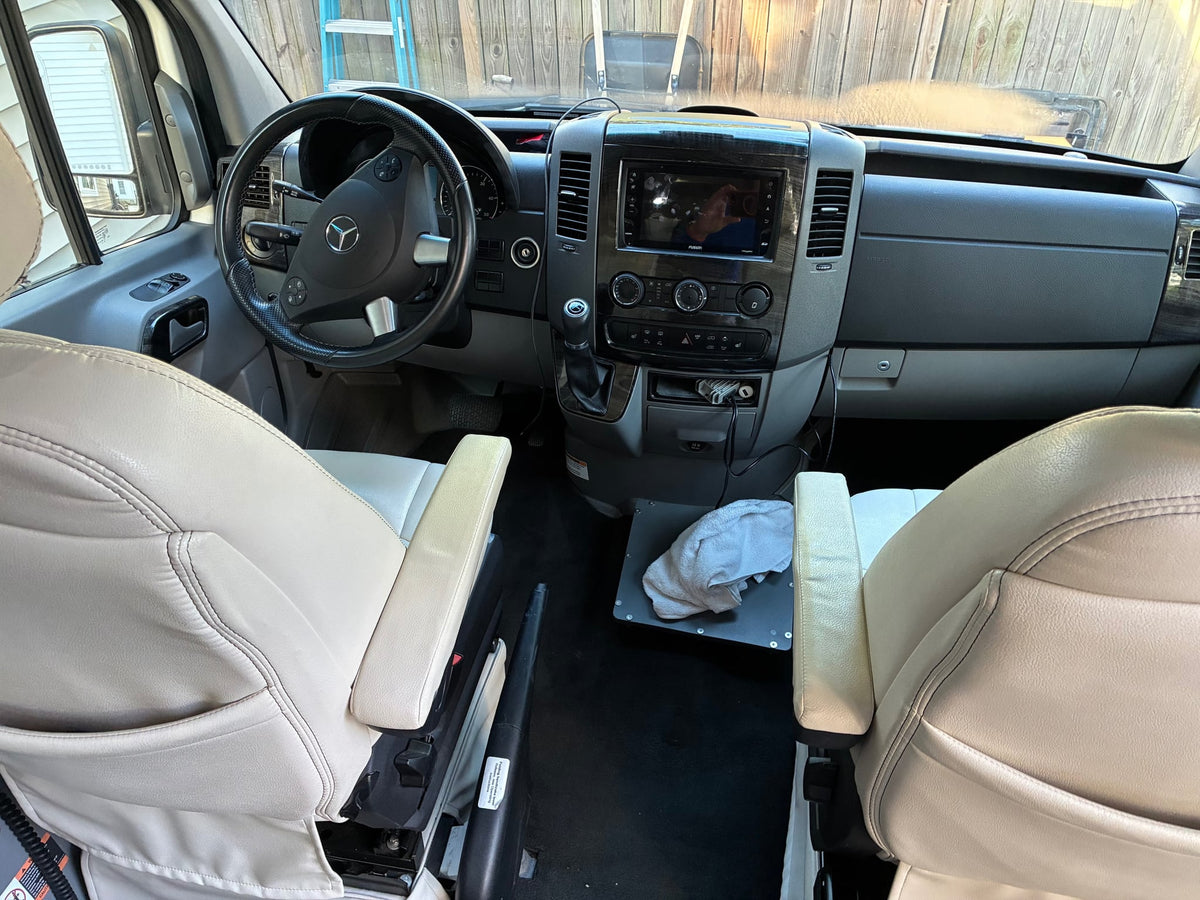 and driver's cabin in view.|This RV rental features a cozy camper van interior with a dining area — photo 8