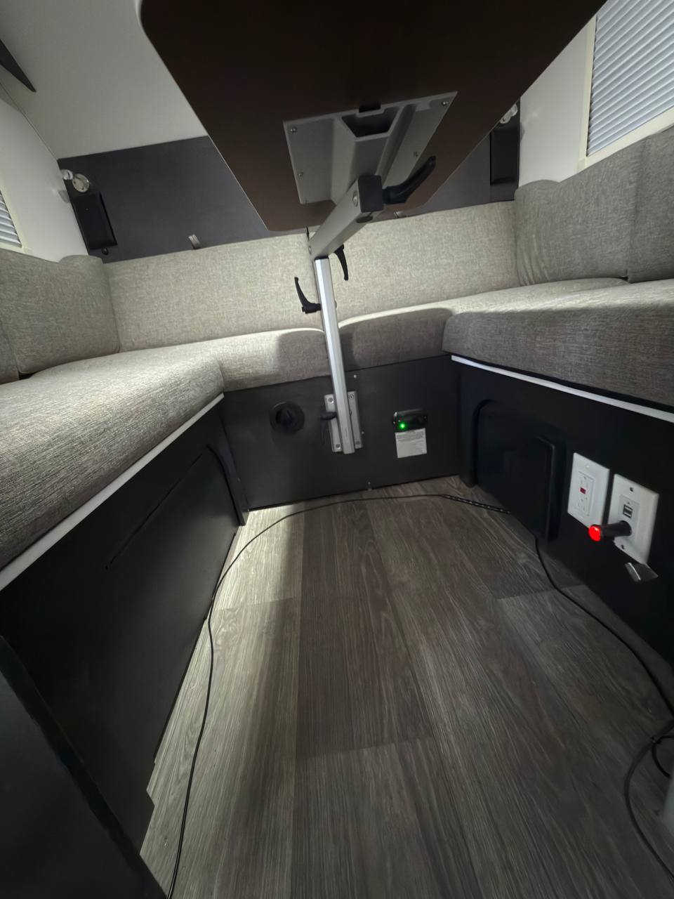 and open overhead cabinets.|Inside an rv rental: an open door reveals a backyard scene with a fence