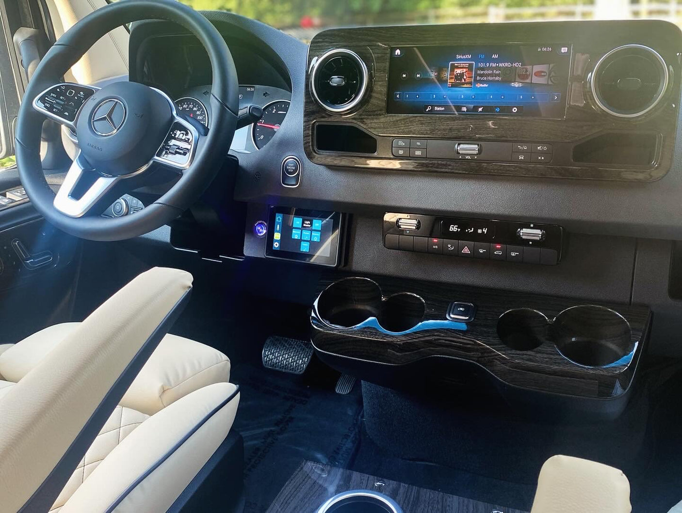 and elegant overhead lighting.|Spacious luxury RV rental interior with cream quilted leather captain's chairs and a microwave for comfort.|Built-in High Pointe microwave