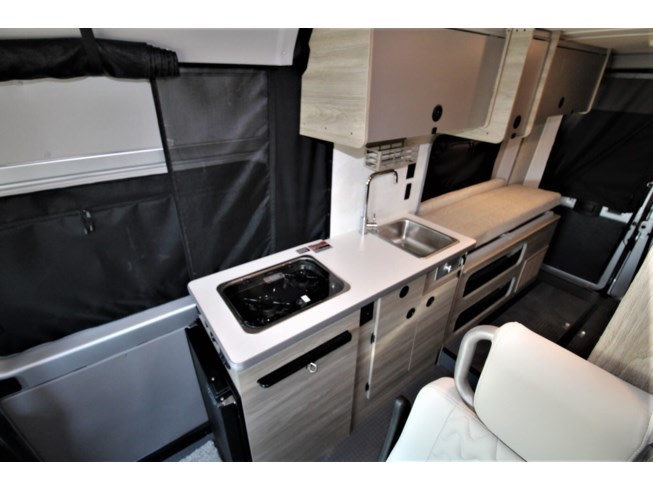 ideal for camper travel.|Compact RV rental interior with bed