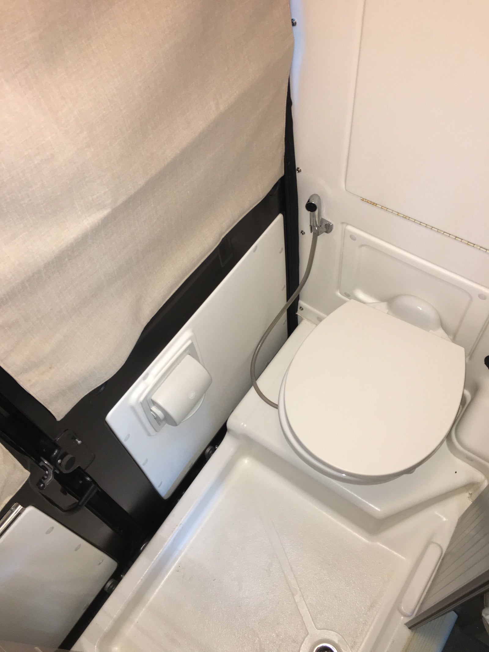 and a bed. A warning label about glass/fire is visible.|An RV rental kitchen
