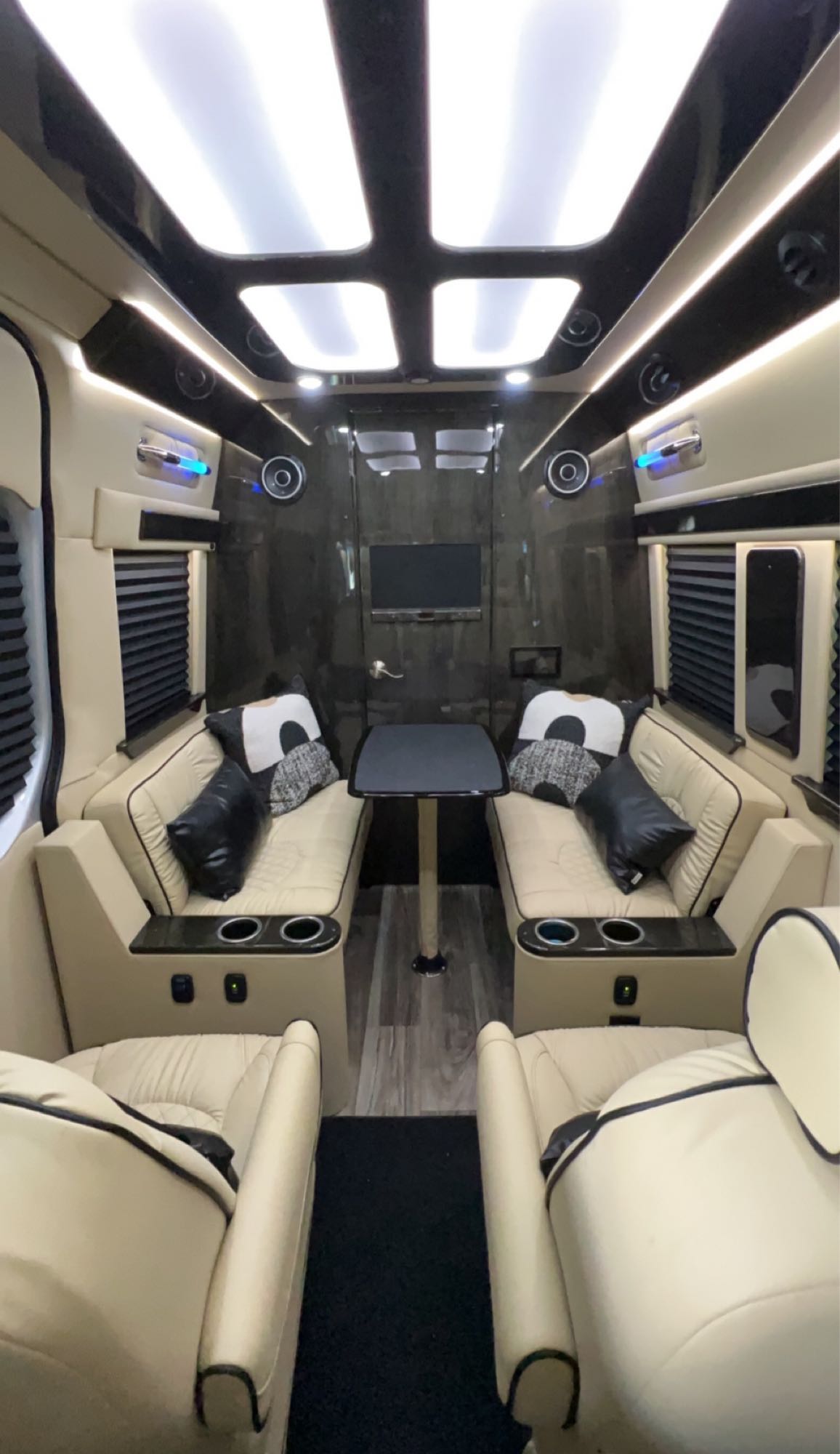 ambient lighting. Ultimate comfort for your journey.|Explore this luxury rv rental's interior: two plush cream quilted seats — photo 7