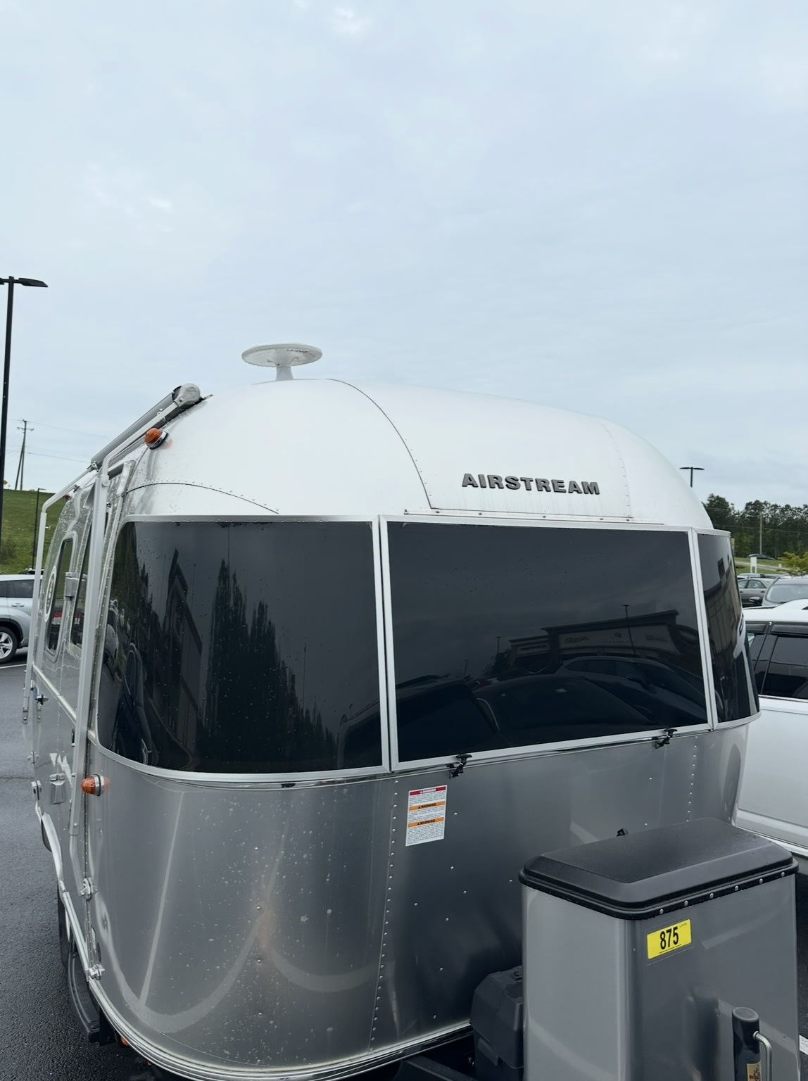 and privacy blinds.|Inside a spacious rv rental: modern travel trailer interior with shiny aluminum walls