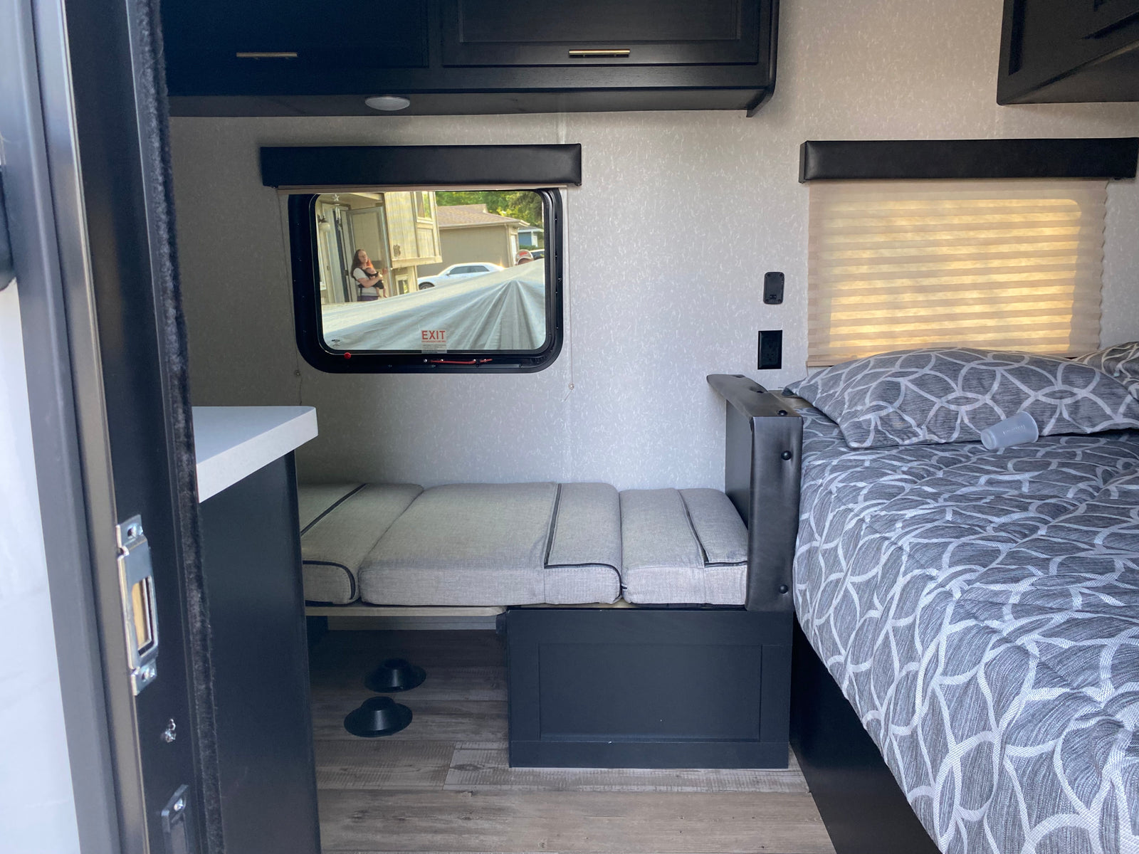 Inside a modern **rv rental**: comfy bed, versatile seating, and sleek storage. Ready for your road trip comfort!