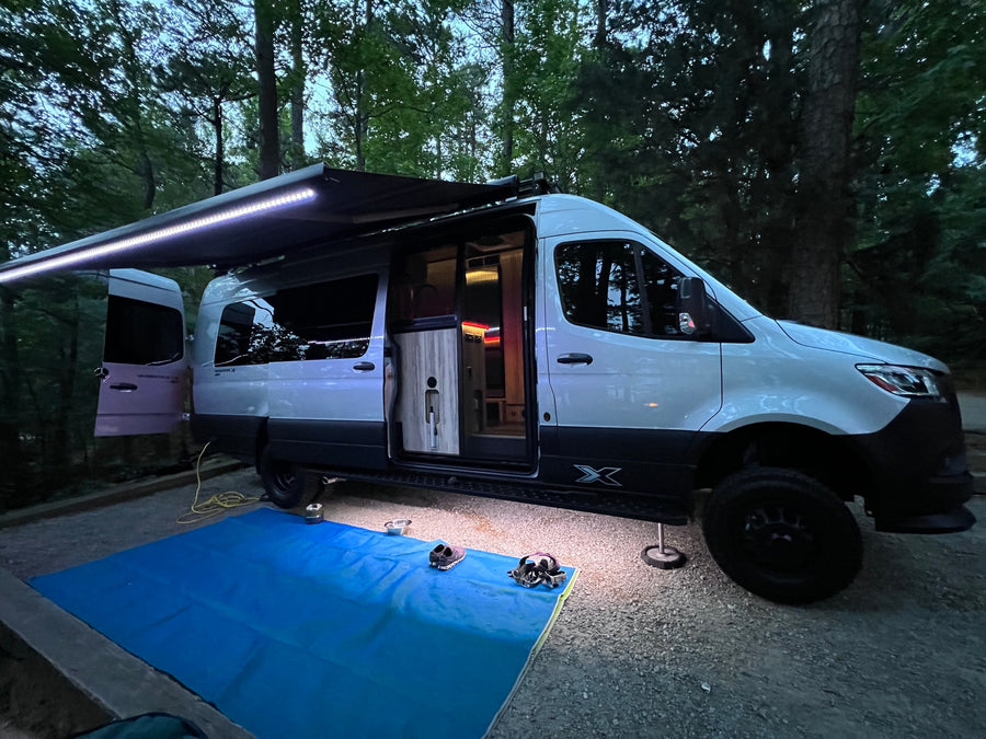 ready for outdoor living.|Beachfront RV rental setup: An Airstream van parked