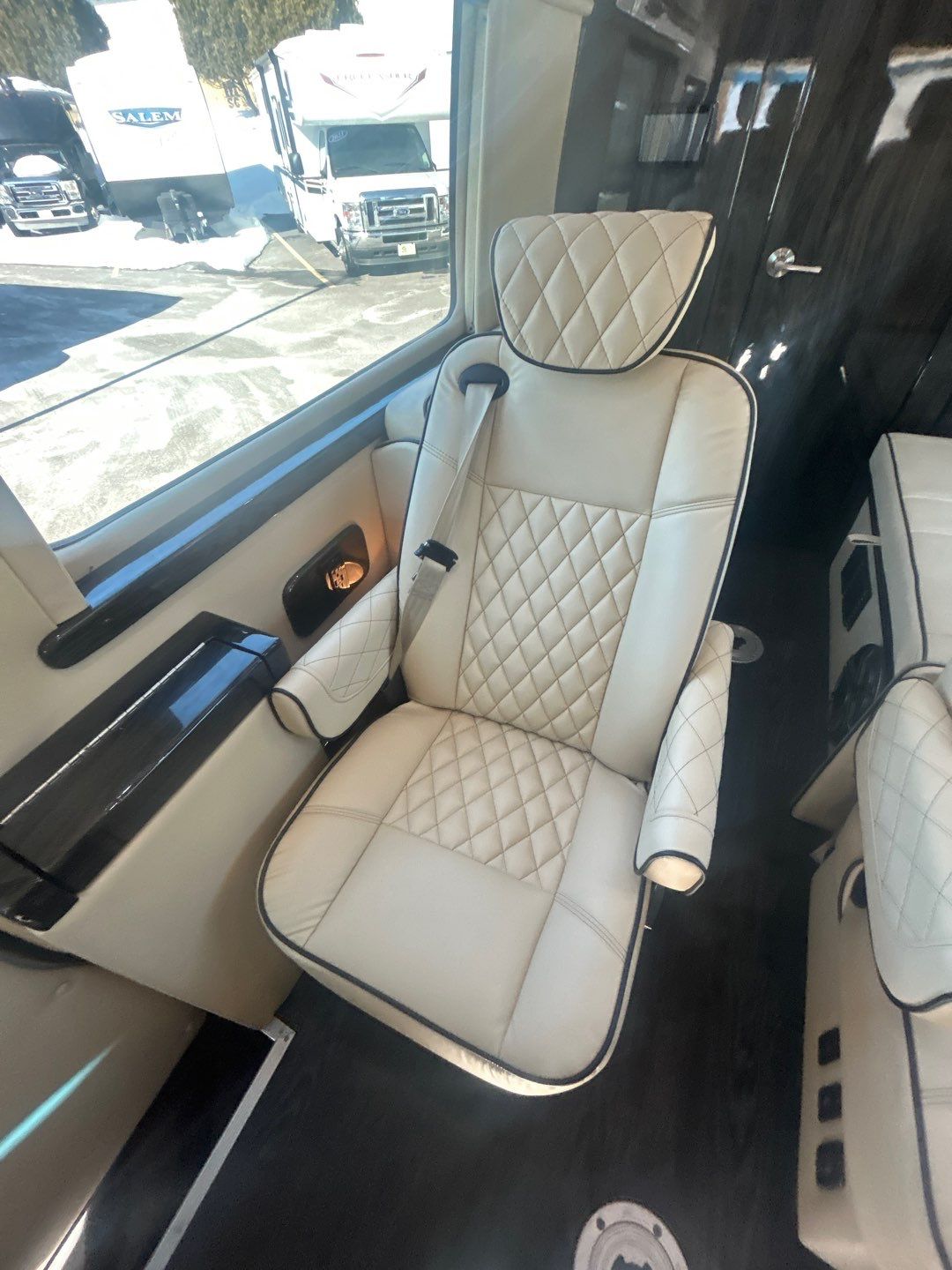 and ample space for travel.|Modern RV rental interior featuring a quilted white bench seat