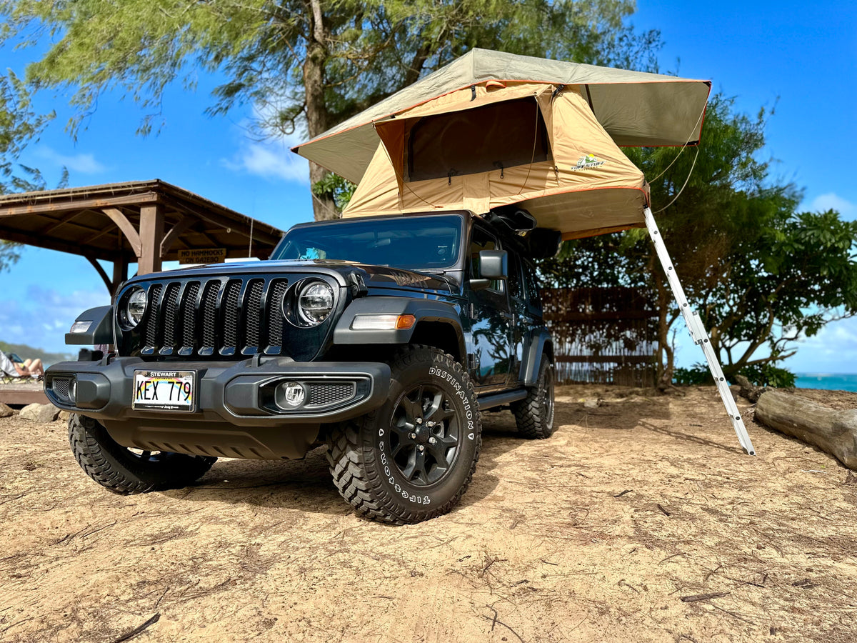 Black Jeep with a rooftop tent set up for camping on a sandy Hawaiian beach. Ideal RV rental alternative for outdoor adventures. — photo 5