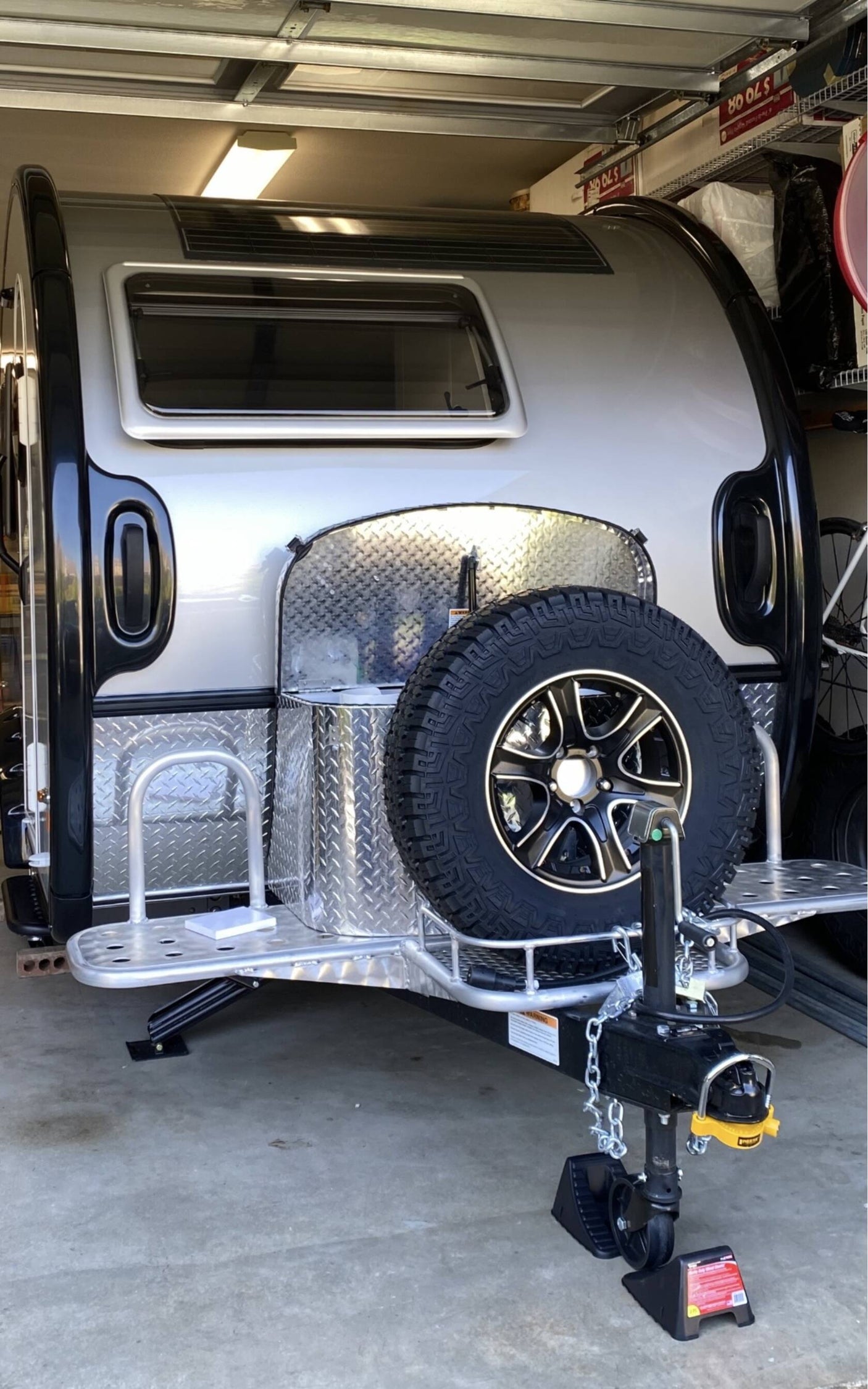 great for rv rental adventures.|Dark SUV towing a compact teardrop RV. A larger Dutchmen RV is parked nearby