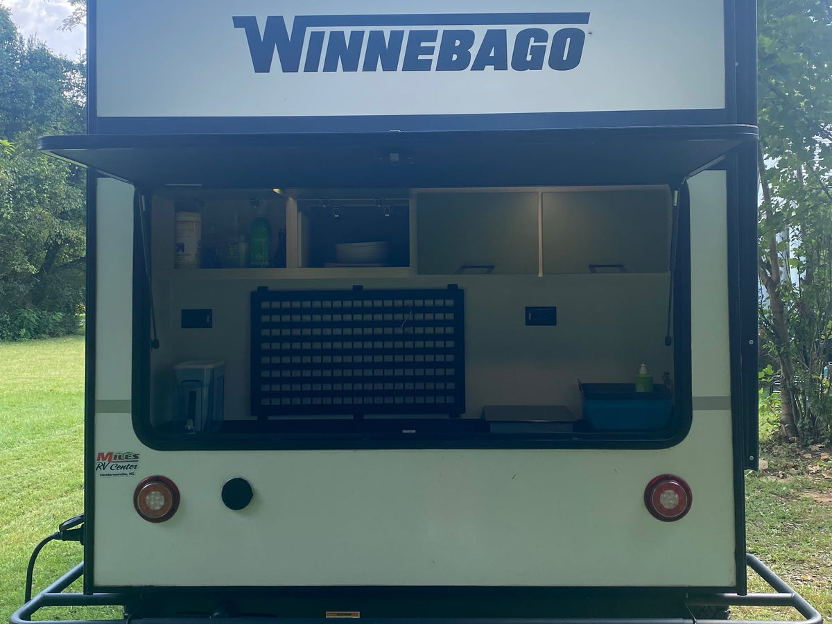 and green storage cabinets.|A cozy rv rental bedroom: bed with green blanket — photo 12