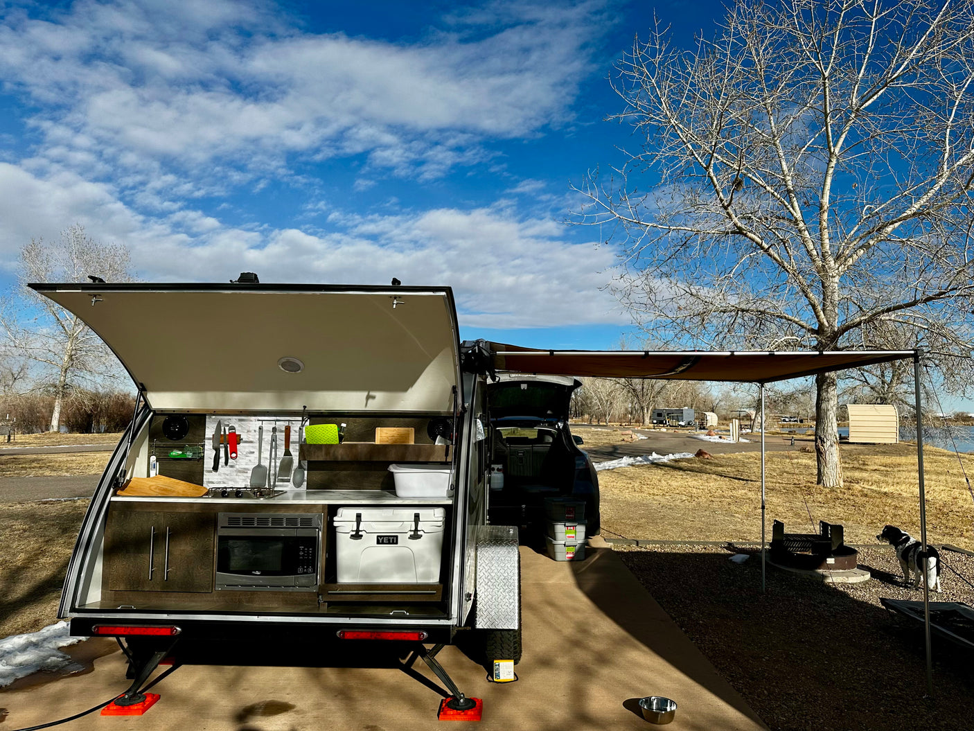 is parked at a snowy campsite under a blue sky