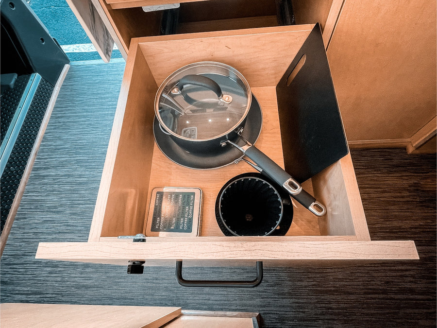 and warm wood accents create a perfect mobile retreat.|Modern RV rental interior with wood details