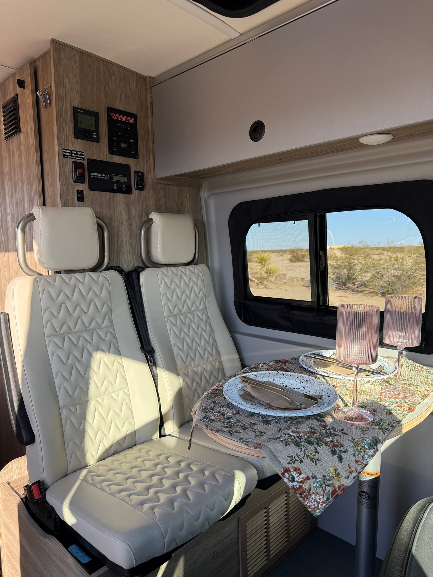 ready for adventure.|Inviting RV rental interior: a bed with patterned linens